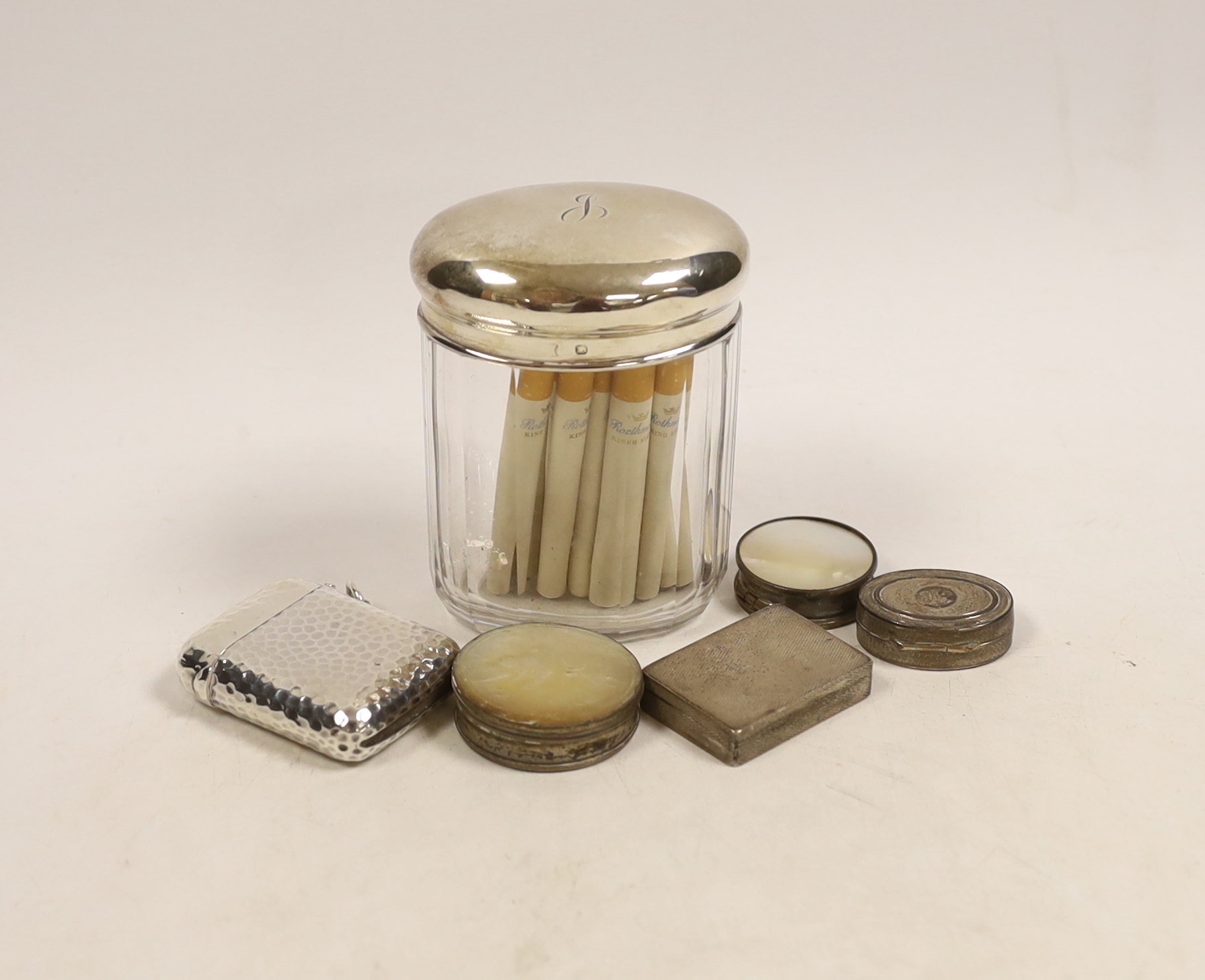 A large hammered silver vesta case by Sampson Mordan & Co., London 1900, 56mm, a small engine turned silver oblong pill box (London 1933) and four other items.
